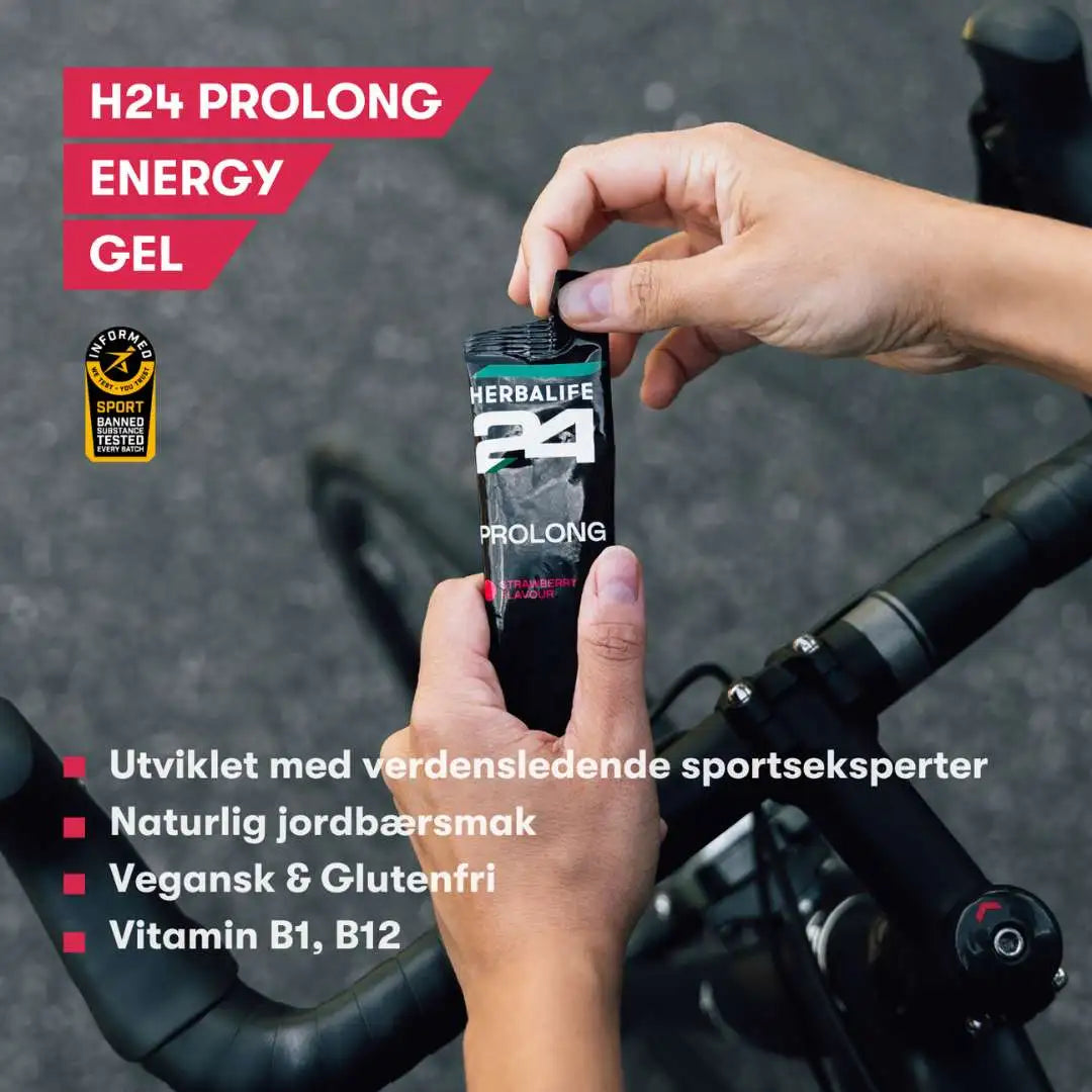 En porsjonspose Herbalife H24 Prolong Energy Gel i hendene på en syklist. Tekst på bildet: H24 Prolong Energy Gel. Utviklet med verdensledende sportseksperter. Naturlig jordbærsmak. Vegansk og glutenfri. Vitamin B1, B12.
