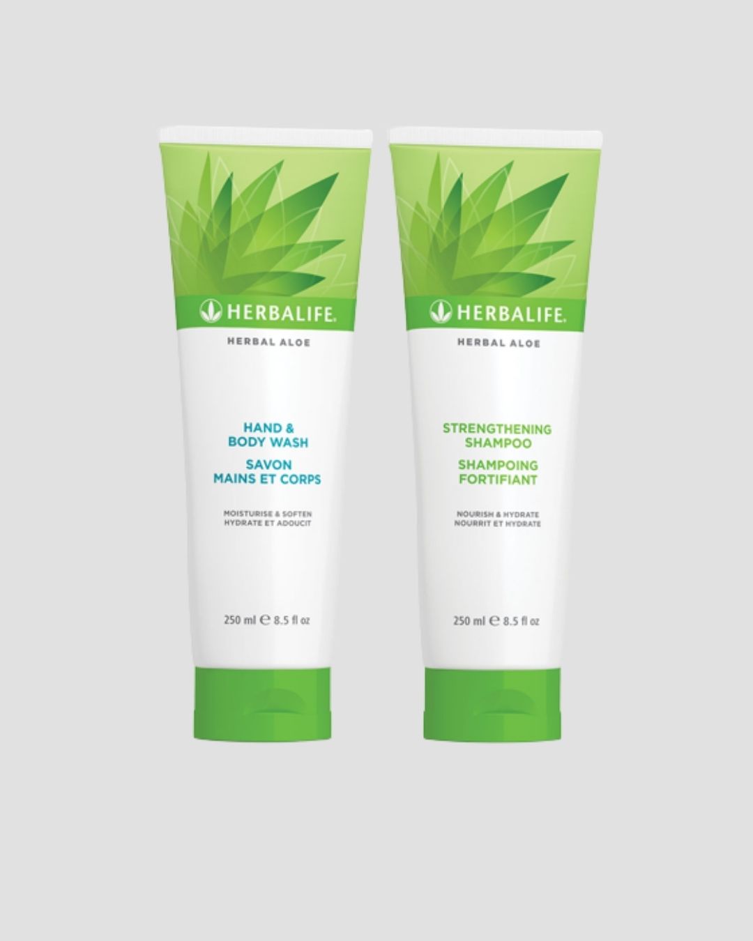 En tube Herbalife Herbal Aloe Strengthening Shampoo og Hand & Body Wash på grå bakgrunn.