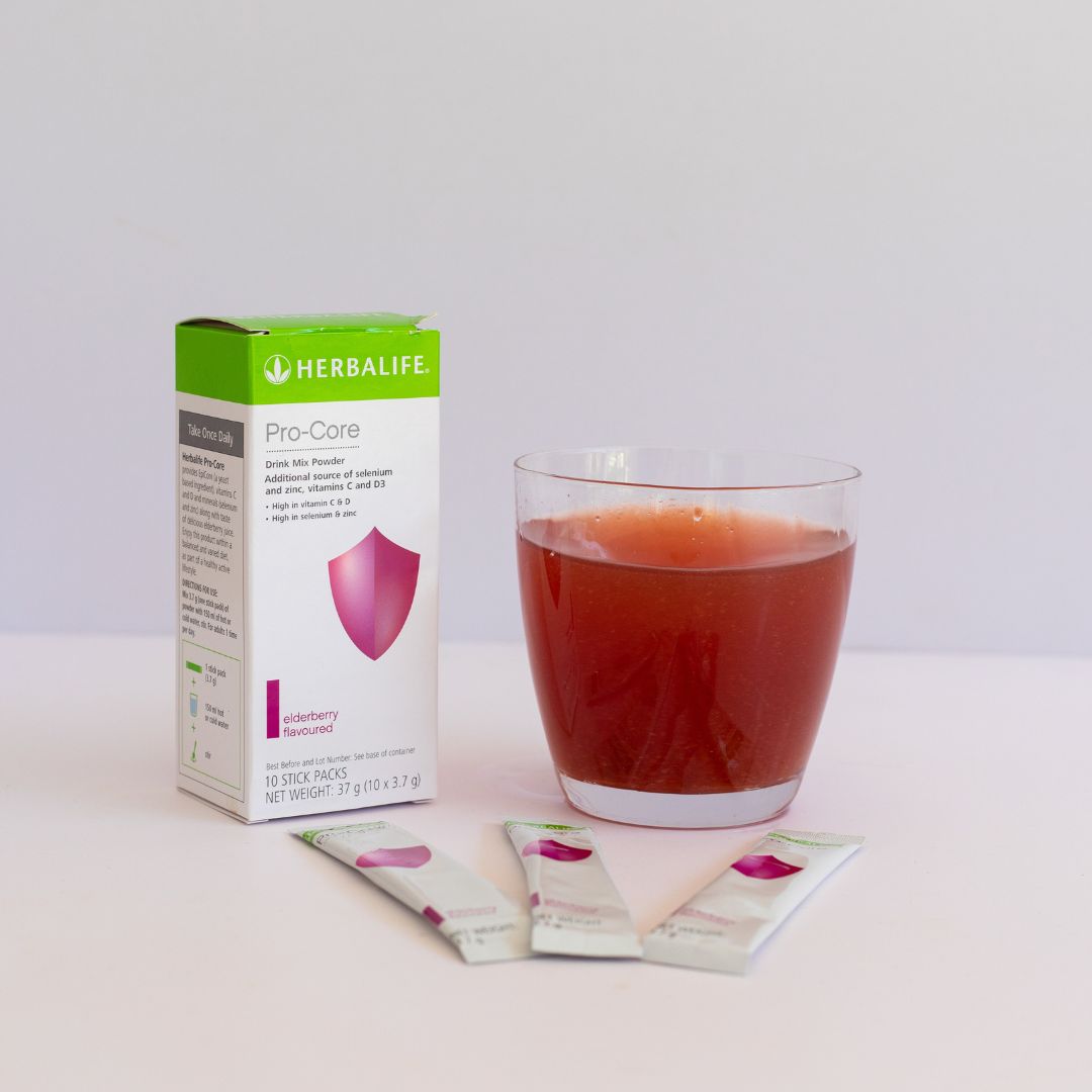 En pakke Herbalife Immune Booster, tre løse porsjonsposer og et glass vann med drikkeklar Immune Booster. 