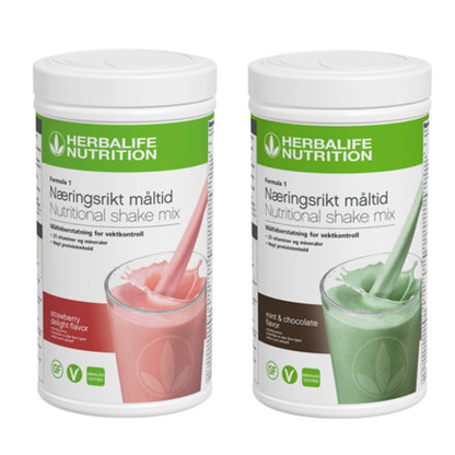 En boks Herbalife Formula 1 shakemix med jordbærsmak og en med mintsjokoladesmak.