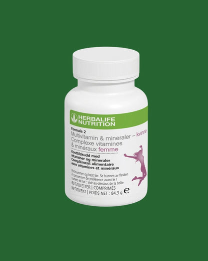 Multivitamin-boks på grønn bakgrunn. Tekst på boksen: Herbalife Formula 2 Multivitamin & mineraler - kvinne. Kosttilskudd med vitaminer og mineraler for kvinner. 