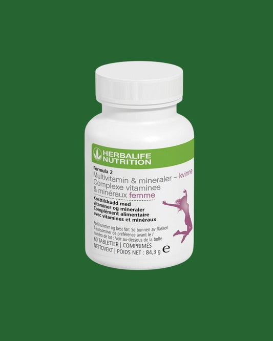 Multivitamin-boks på grønn bakgrunn. Tekst på boksen: Herbalife Formula 2 Multivitamin & mineraler - kvinne. Kosttilskudd med vitaminer og mineraler for kvinner. 