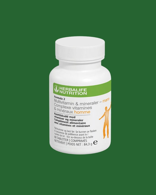 Multivitamin-boks for menn på grønn bakgrunn. Tekst på boksen: Herbalife Formula 2 Kosttilskudd med vitaminer og mineraler - mann. 