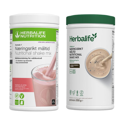 En boks Herbalife Formula 1 shakemix med bringebær og hvit sjokoladesmak og en med cookie crunch-smak.