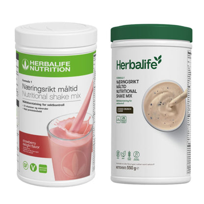 En boks Herbalife Formula 1 shakemix med jordbærsmak og en med cookie crunch-smak.